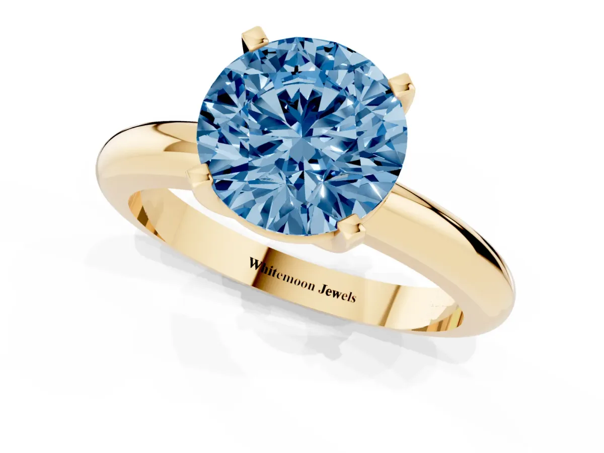Fancy Blue Round Cut Diamond Solitaire Engagement Ring with Round Band and Four-Prong Setting Yellow gold