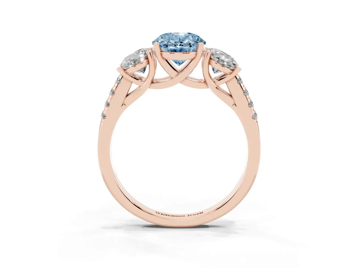 Fancy Blue Three-Stone Oval Cut Diamond Ring with Round Pavé Band and Prong Setting Rose gold