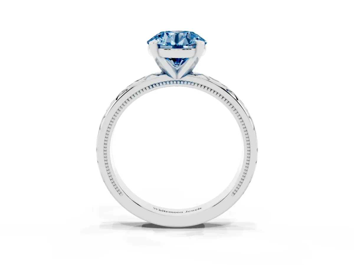 Fancy Blue Round Cut Solitaire Engagement Ring with Scrollwork Band and Four-Prong Setting Silver