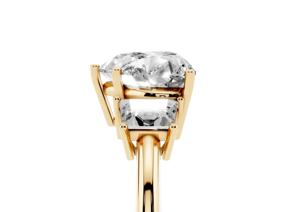 Heart Cut Diamond Three-Stone Ring with Trapezoid Side Stones and Prong Setting Yellow gold