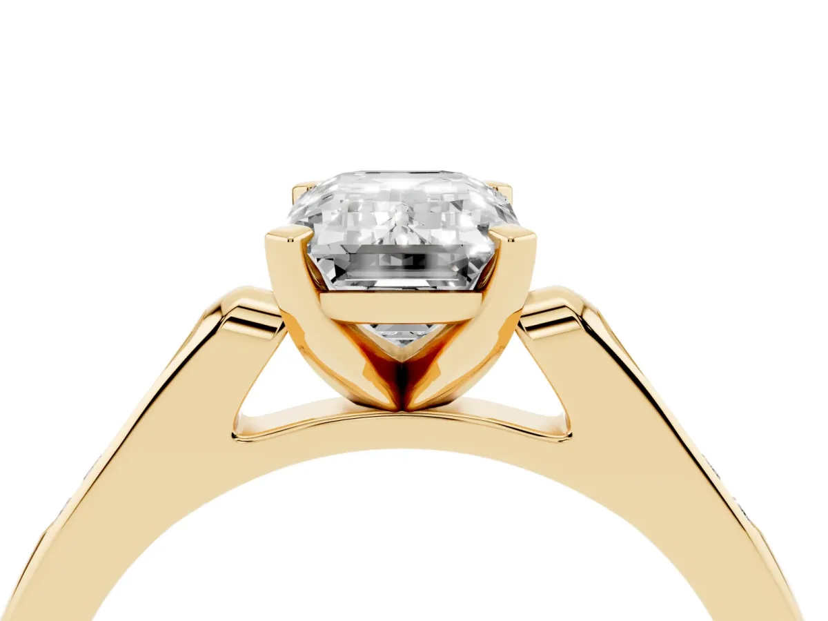 Emerald Cut Diamond Solitaire Ring with Channel Set Round Band and Prong Setting Yellow gold