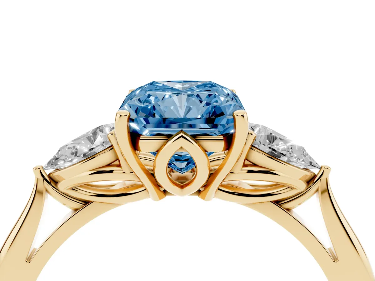 Fancy Blue Three-Stone Radiant Cut Diamond Ring with Pear Side Stones in Four-Prong Setting Yellow gold