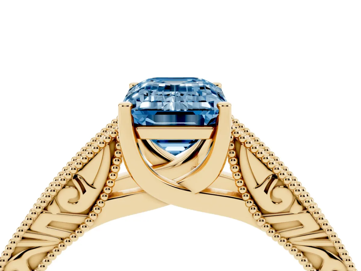 Fancy Blue Emerald Cut Diamond Solitaire Ring with Engraved Band and Four-Prong Setting Yellow gold