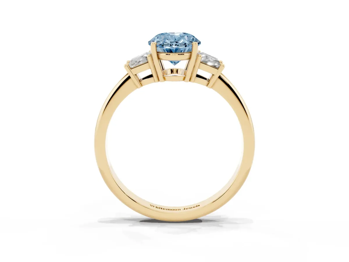Fancy Blue Oval Cut Diamond Three-Stone Ring with Trapezoid Side Stones and Prong Setting Yellow gold