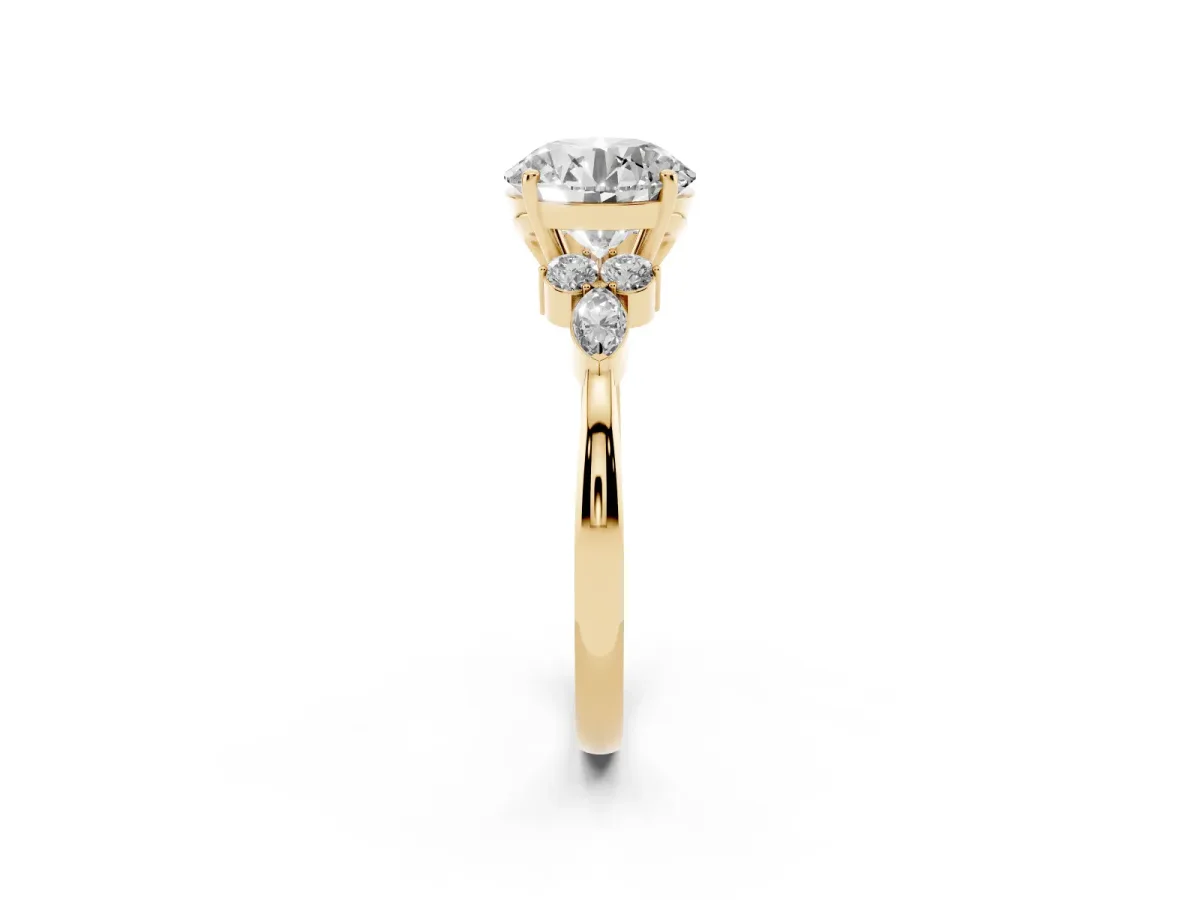 Round Cut Brilliant Diamond Solitaire Ring with Pear Side Stones and Four-Prong Setting Yellow gold