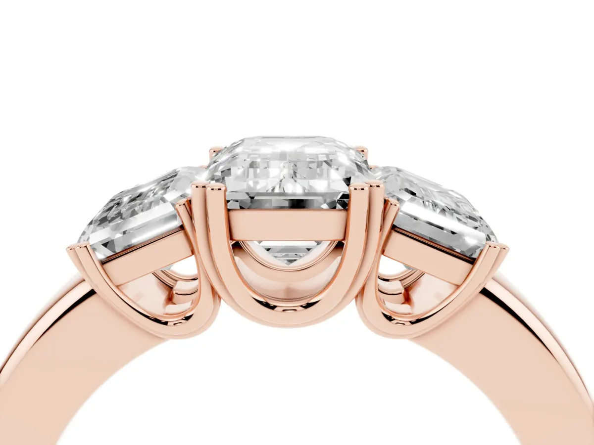 Three-Stone Emerald Cut Cut Diamond Ring with Channel Set Band and Four-Prong Setting Rose gold