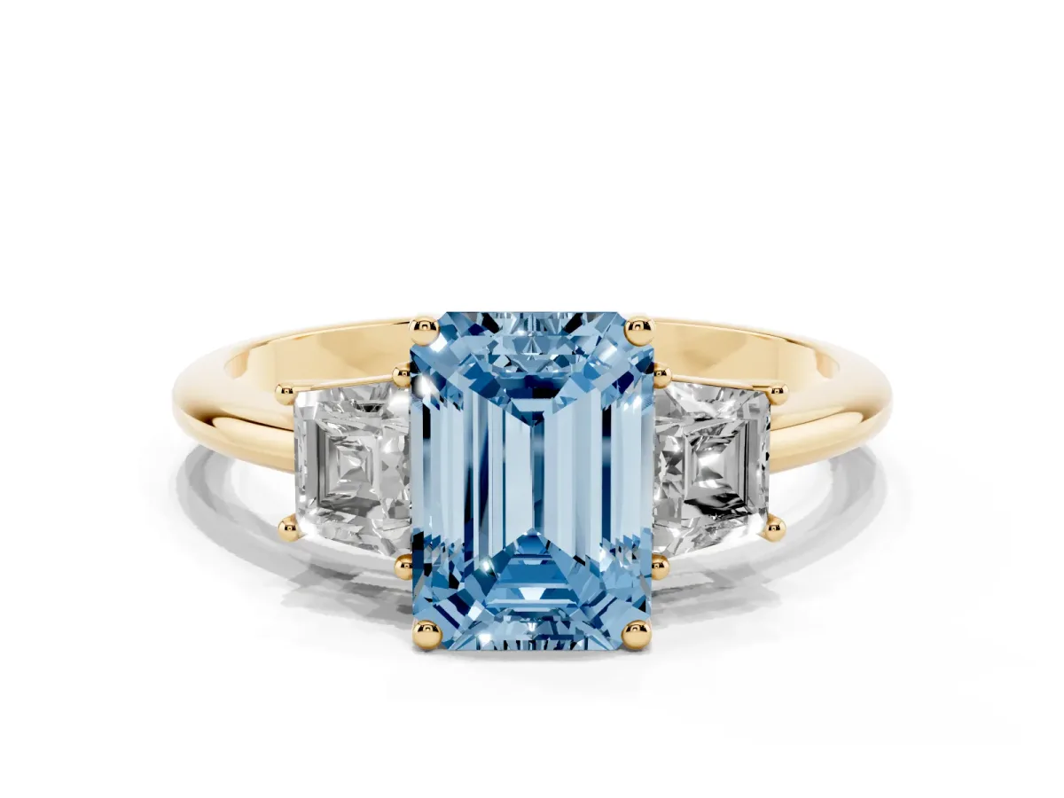 Fancy Blue Emerald Cut Diamond Three-Stone Ring with Trapezoid Side Stones and Prong Setting Yellow gold