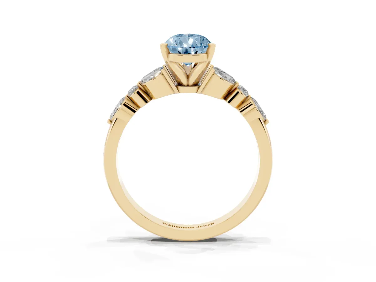 Fancy Blue Pear Cut Diamond Solitaire Ring with Side Stones and Four-Prong Setting Yellow gold