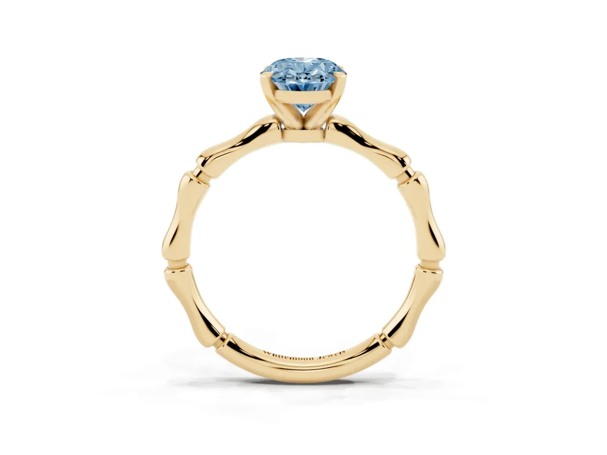 Fancy Blue Oval Cut Solitaire Diamond Ring with Bamboo Band and Four-Prong Setting Yellow gold