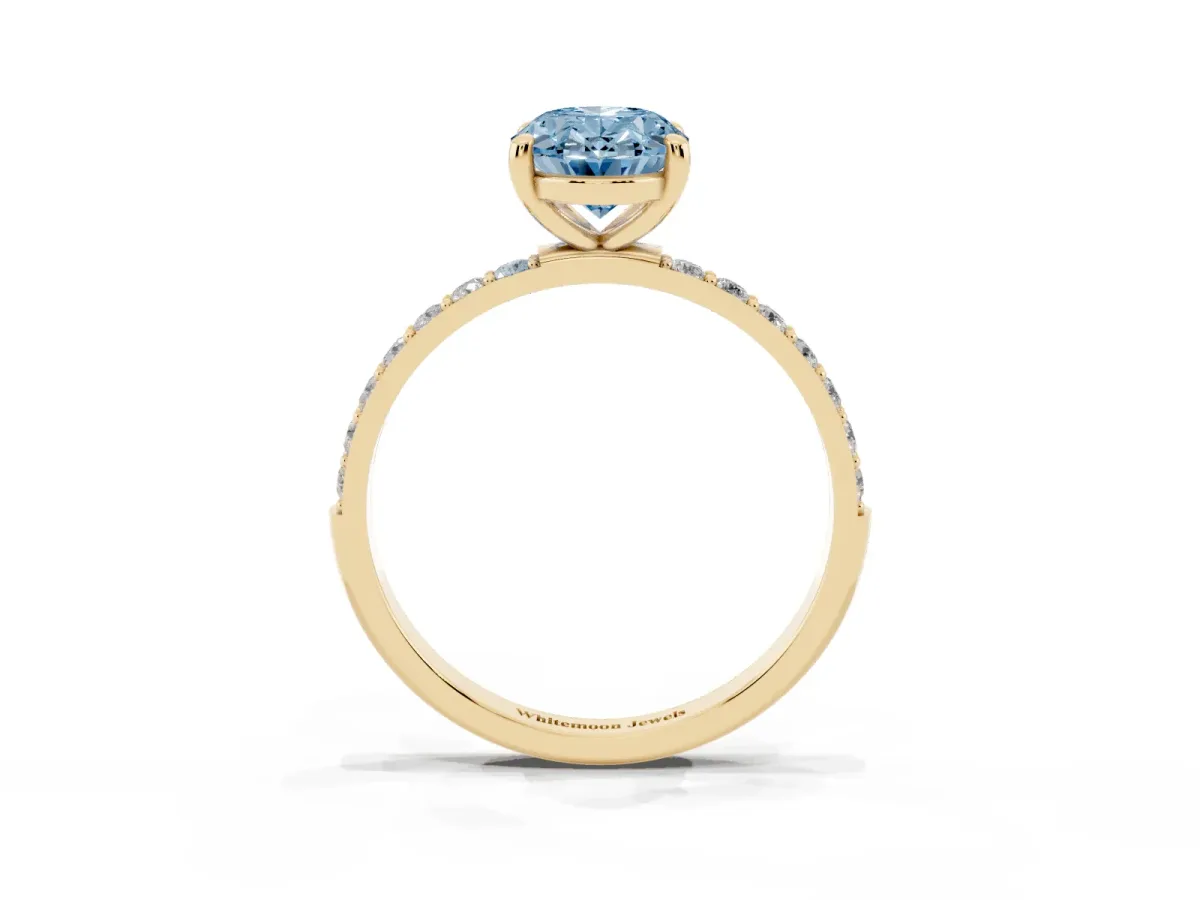 Fancy Blue Oval Cut Diamond Solitaire Ring with Round Pavé Band and Prong Setting Yellow gold