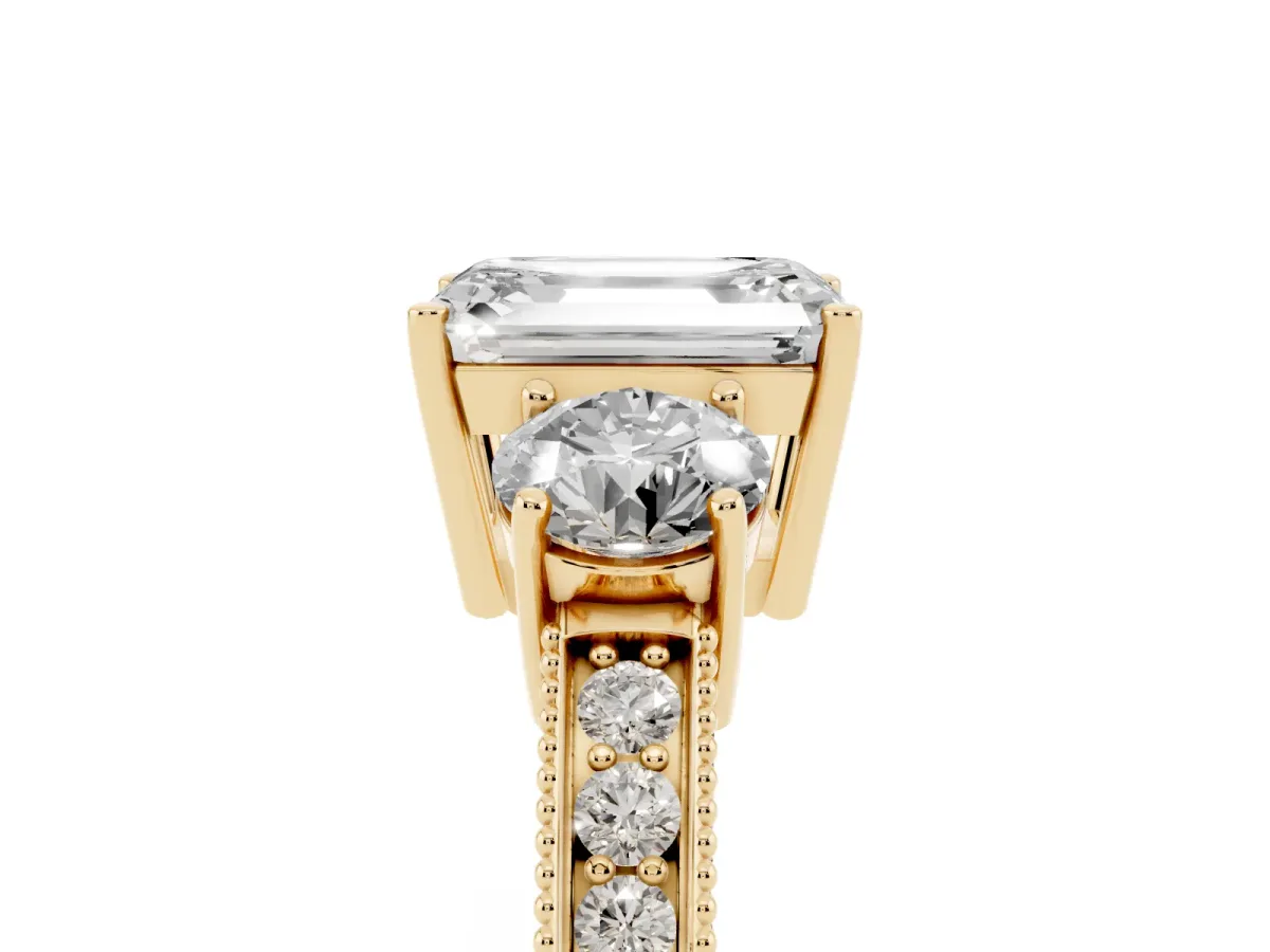 Emerald Cut Three-Stone Diamond Ring with Pavé Band and Four-Prong Setting Yellow gold