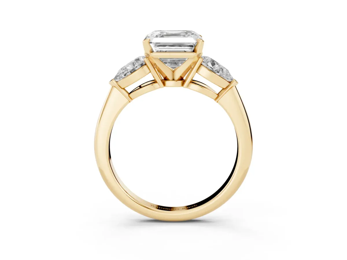 Three-Stone Asscher Cut Diamond Ring with Pear Side Stones and Four-Prong Setting Yellow gold