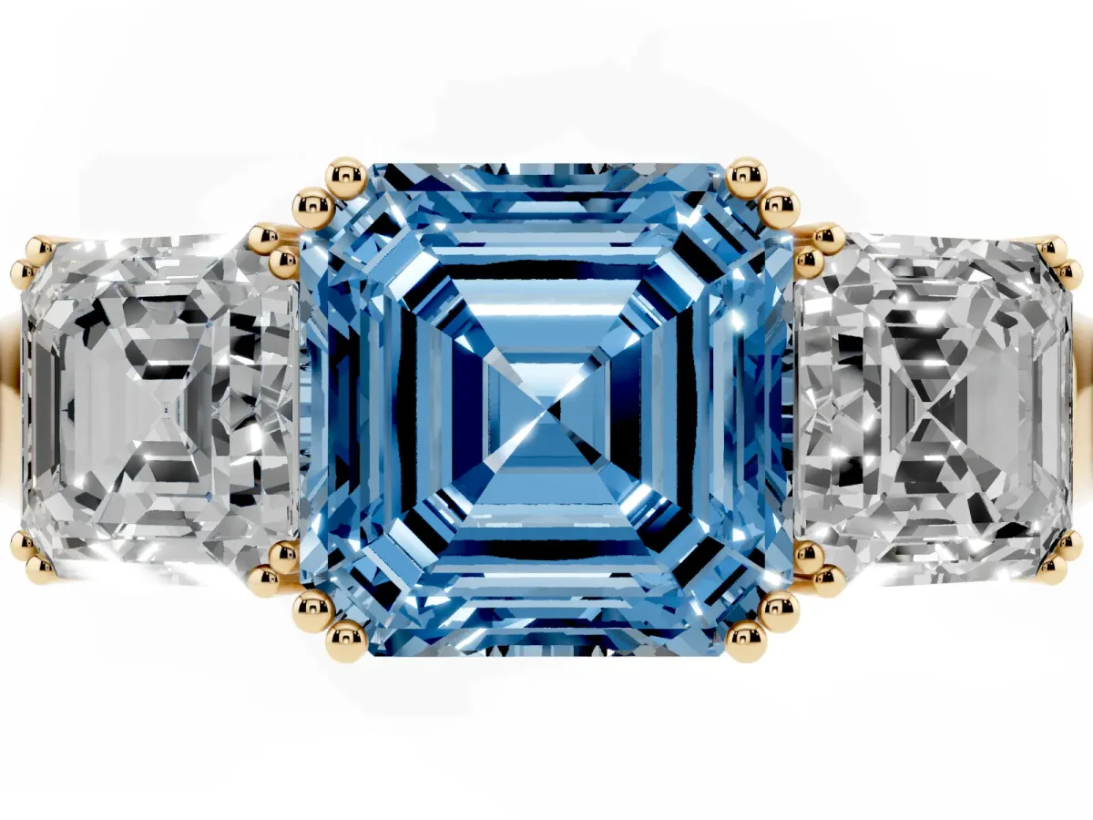 Fancy Blue Three-Stone Asscher Cut Cut Diamond Ring with Channel Set Band and Four-Prong Setting Yellow gold