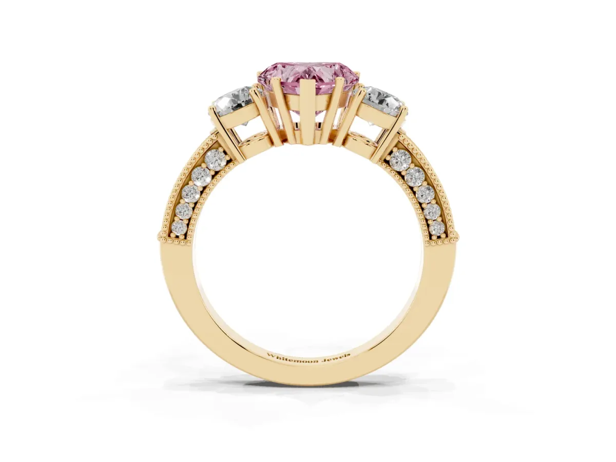 Fancy Pink Heart Cut Three-Stone Diamond Ring with Pavé Band and Four-Prong Setting Yellow gold