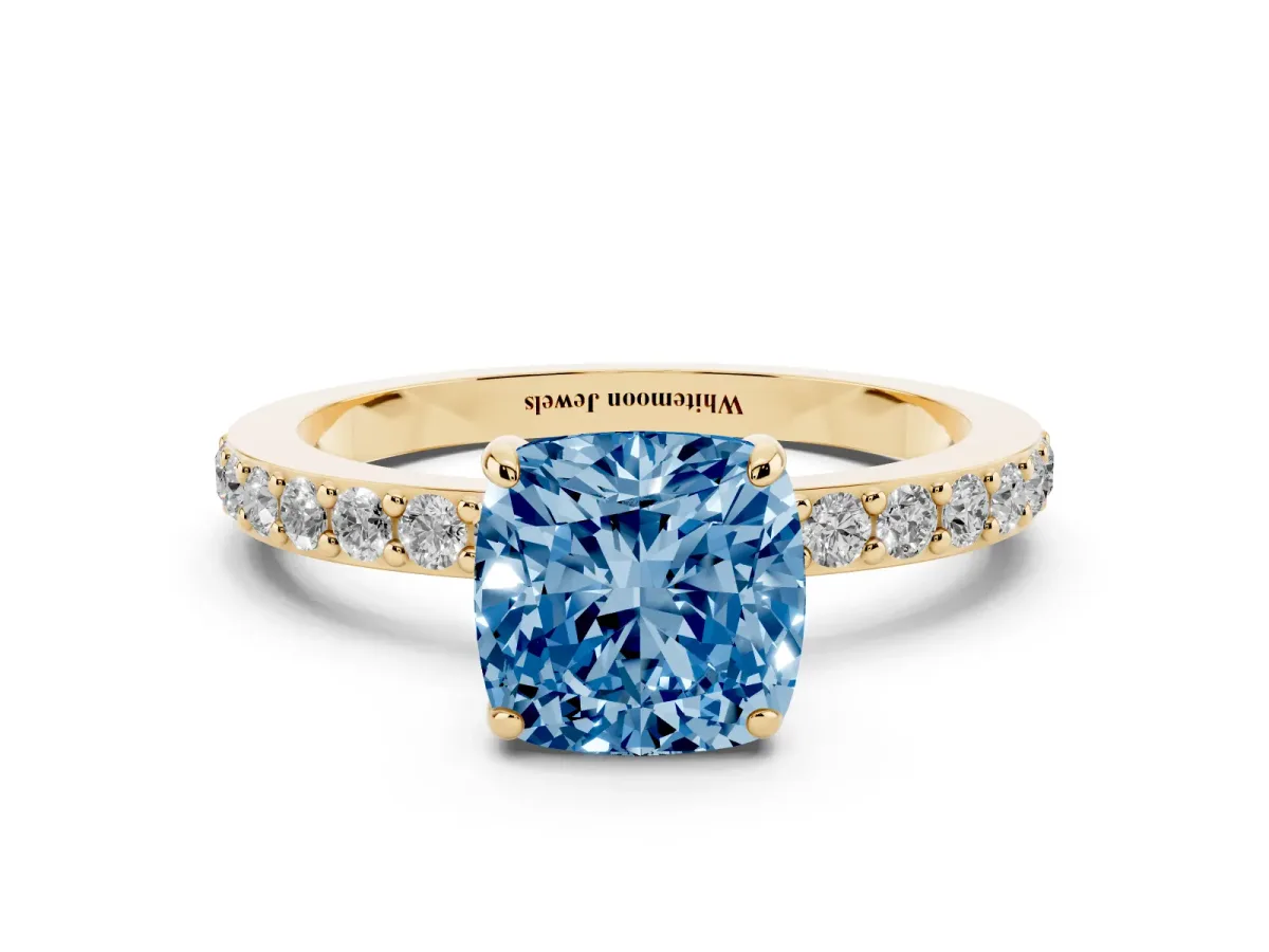 Fancy Blue Cushion Cut Diamond Pavé Engagement Ring with Round Accents and Prong Setting Yellow gold