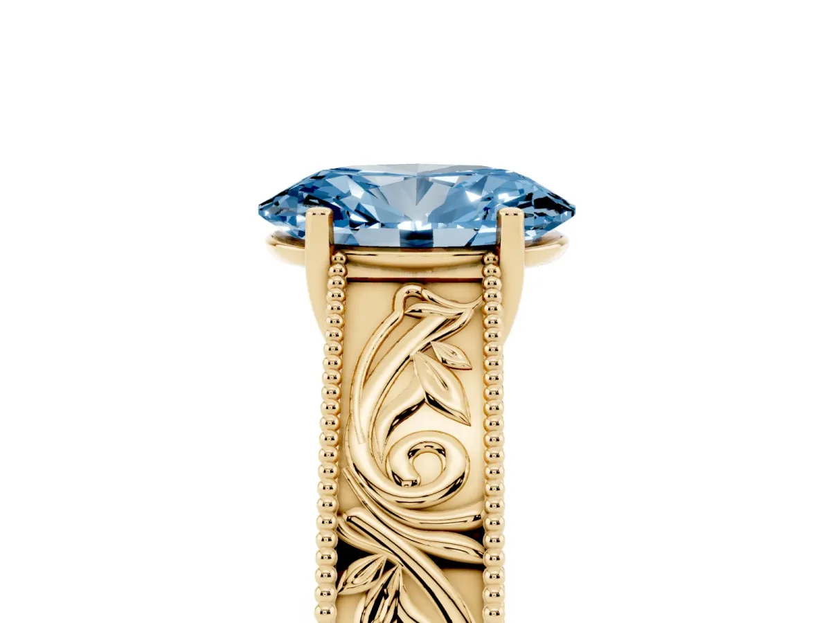 Fancy Blue Oval Cut Diamond Solitaire Ring with Engraved Band and Four-Prong Setting Yellow gold