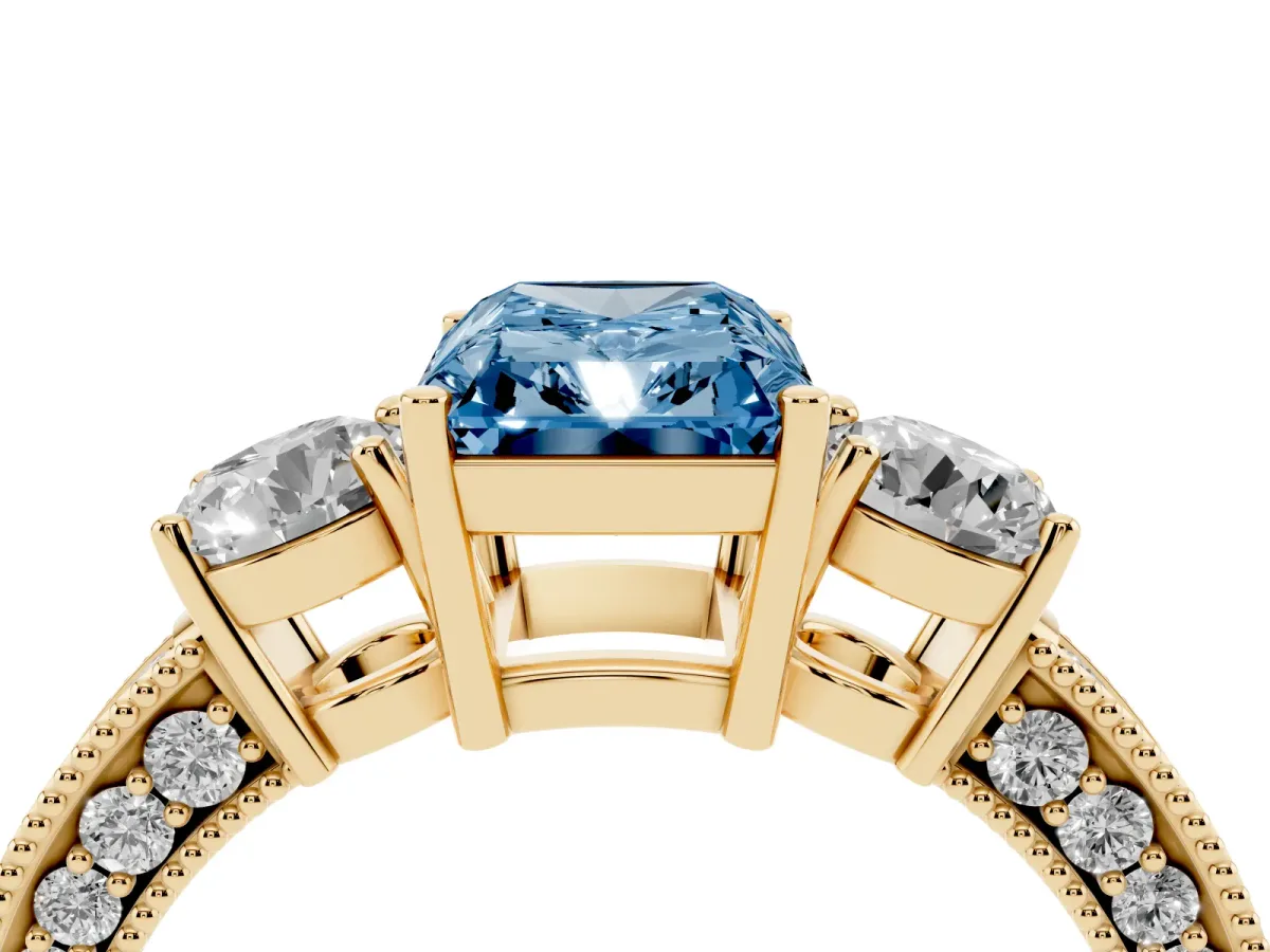 Fancy Blue Radiant Cut Three-Stone Diamond Ring with Pavé Band and Four-Prong Setting Yellow gold