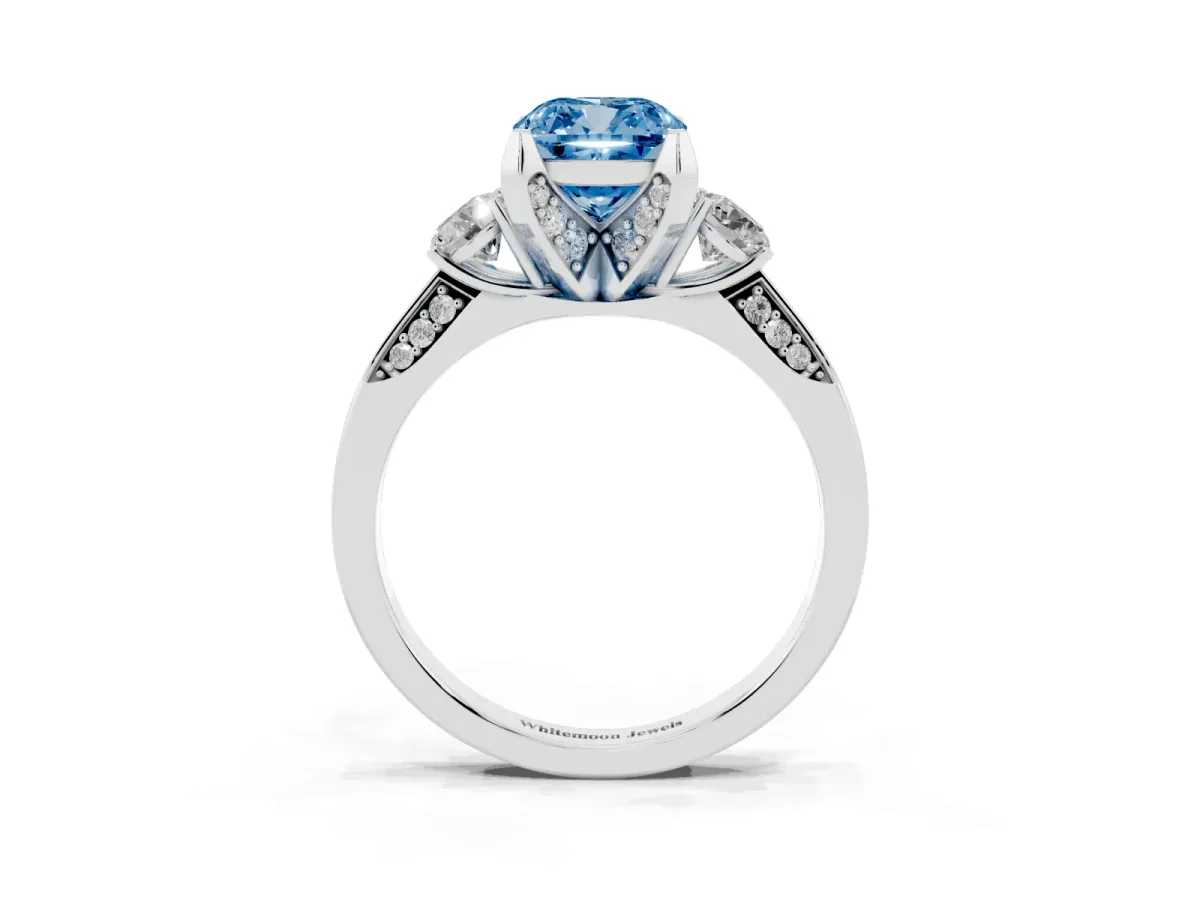 Fancy Blue Cushion Cut Brilliant Three-Stone Diamond Ring with Pavé Band and Four-Prong Setting White gold