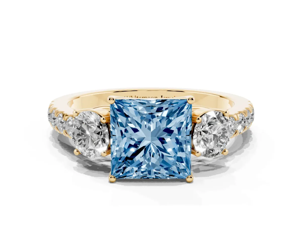 Fancy Blue Princess Cut Cut Diamond Three-Stone Ring with Round Side Stones and Pavé Band Yellow gold