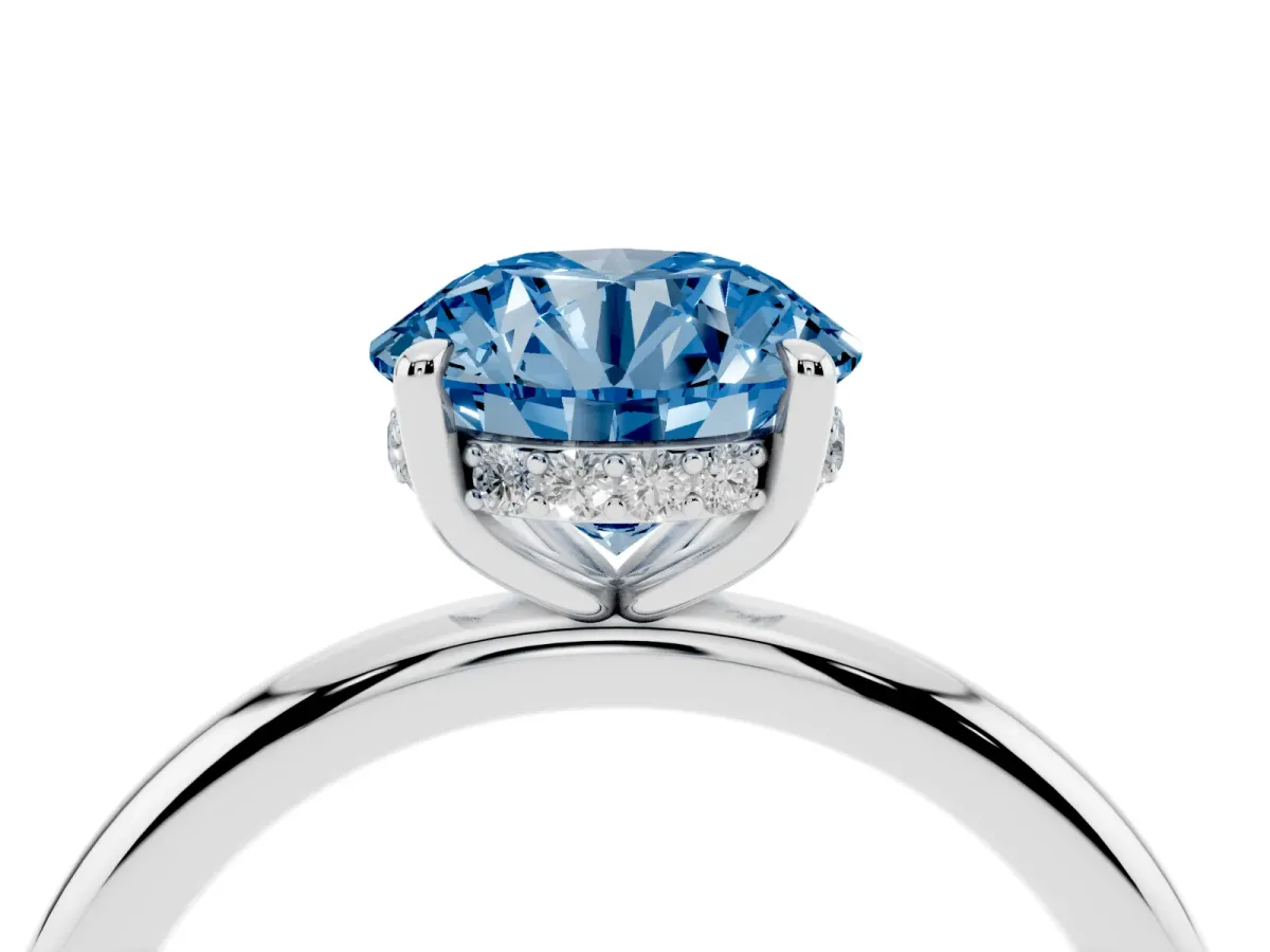 Fancy Blue Round Cut Diamond Solitaire Ring with Thin Band and Four-Prong Setting Silver