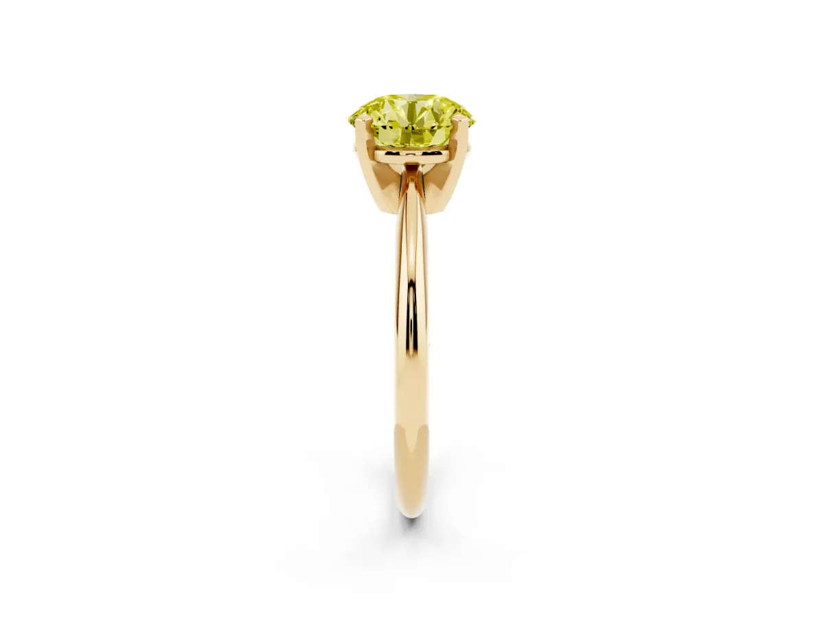 Fancy Yellow Round Cut Cut Solitaire Ring with Four-Prong Setting on a Classic Band Yellow gold