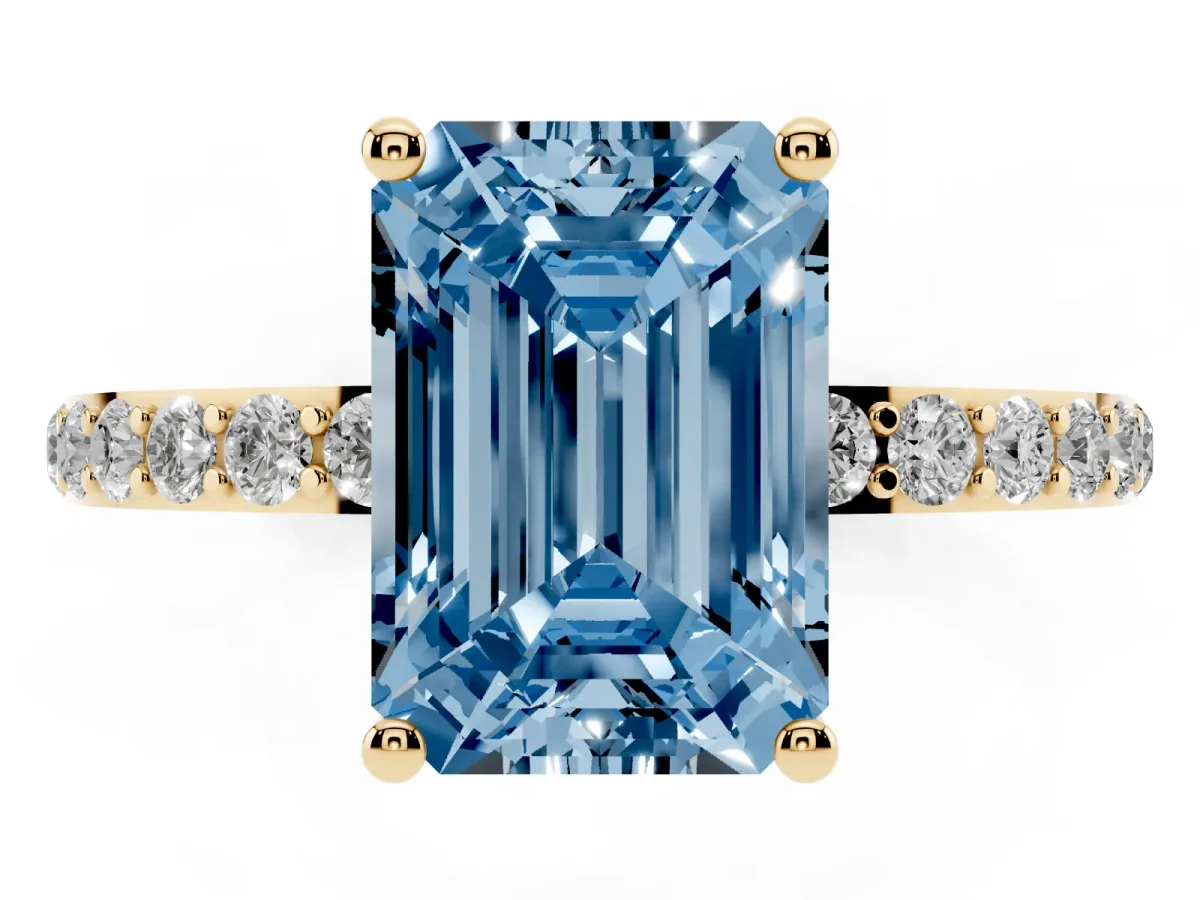 Fancy Blue Emerald Cut Diamond Solitaire Ring with Round Pavé Shoulders and Prong Setting Yellow gold