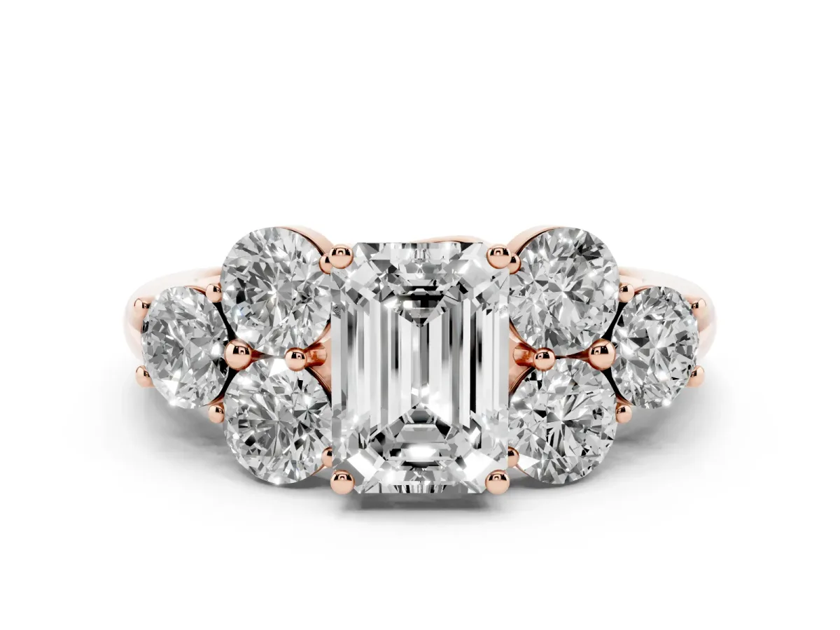 Emerald Cut Cut Diamond Cluster Ring with Round Accent Stones and Prong Setting on a Classic Band Rose gold