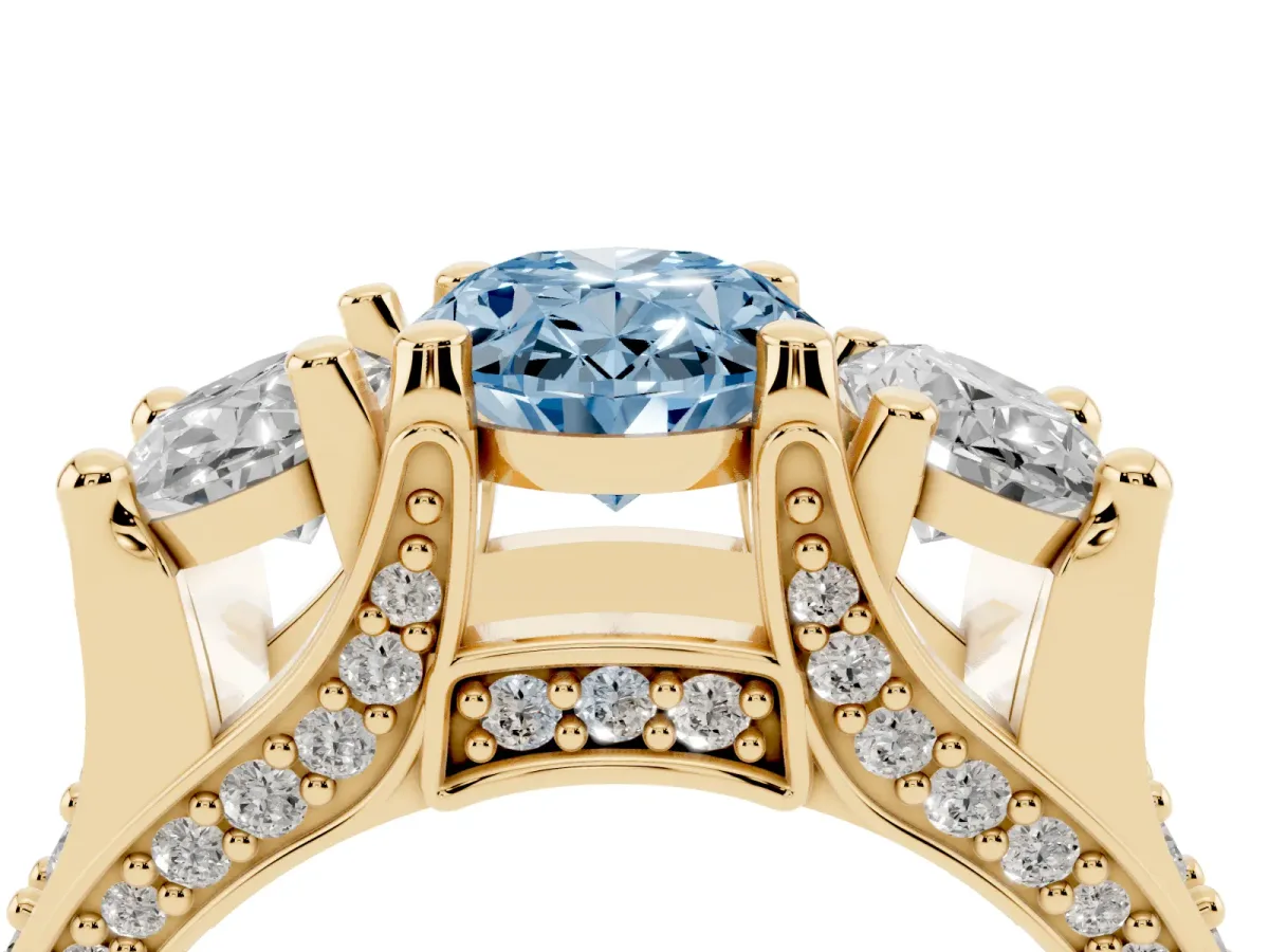 Fancy Blue Oval Cut Diamond Three-Stone Ring with Channel Set Band and Four-Prong Setting Yellow gold