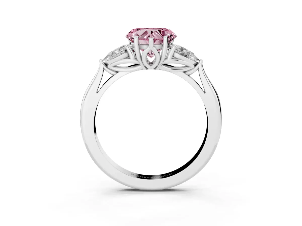 Fancy Pink Three-Stone Heart Cut Brilliant Diamond Solitaire Ring with Tapered Band and Four-Prong Setting White gold