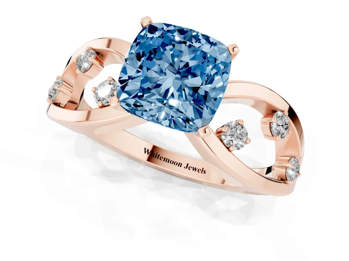 Fancy Blue Cushion Cut Cut Solitaire Diamond with Side Stones on Criss-Cross Band and Four-Prong Setting Rose gold