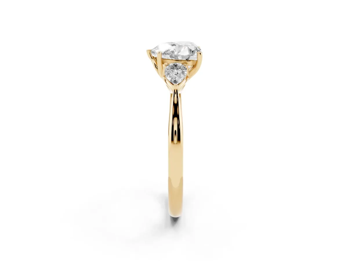 Three-Stone Heart Cut Diamond Ring with Pear Side Stones in Four-Prong Setting Yellow gold
