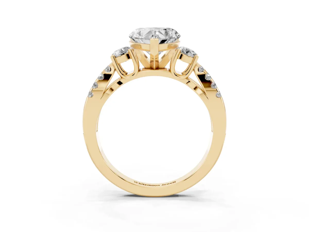 Heart Cut Diamond Three-Stone Ring with Pavé Split Shank and Four-Prong Setting Yellow gold