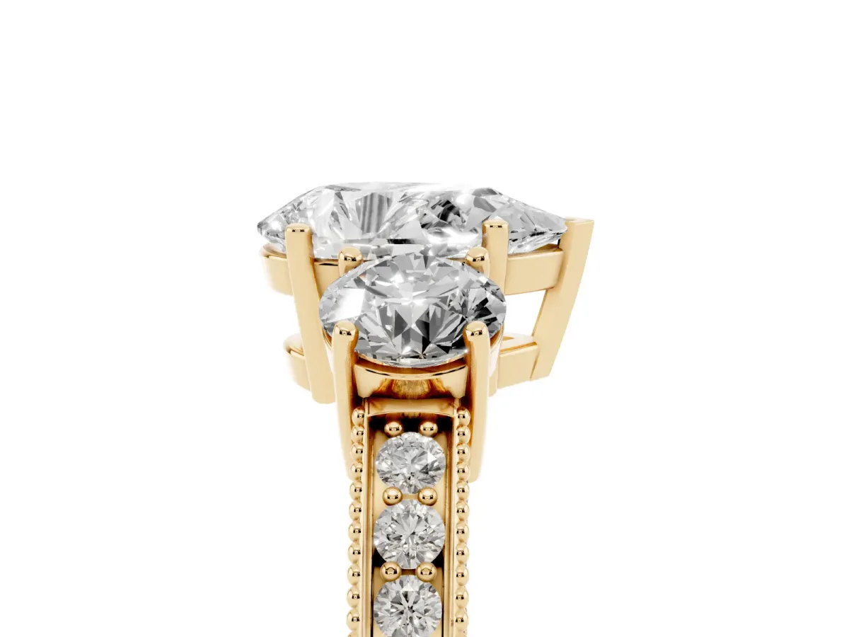 Pear Cut Three-Stone Diamond Ring with Pavé Band and Four-Prong Setting Yellow gold