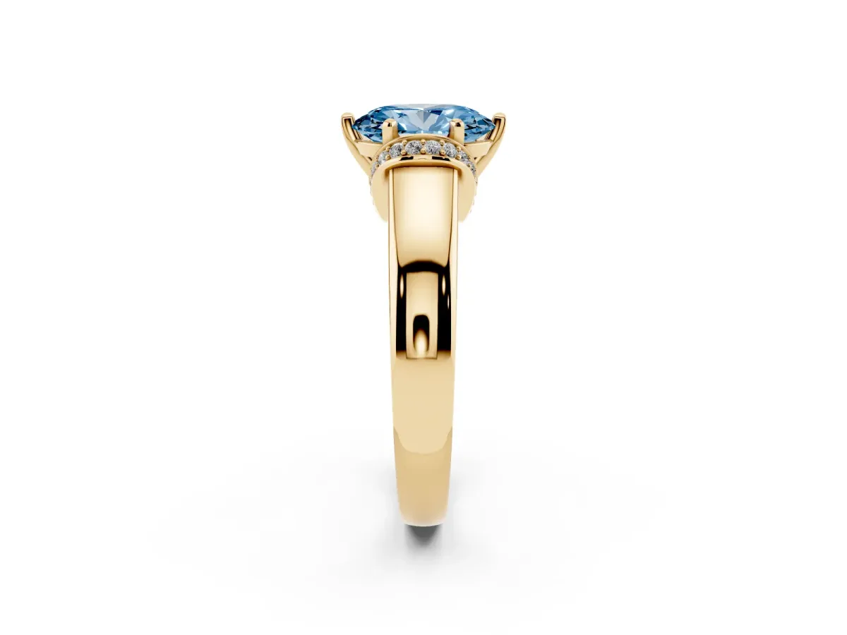 Fancy Blue Oval Cut Solitaire Diamond Ring with Pave Band and Six-Prong Setting Yellow gold