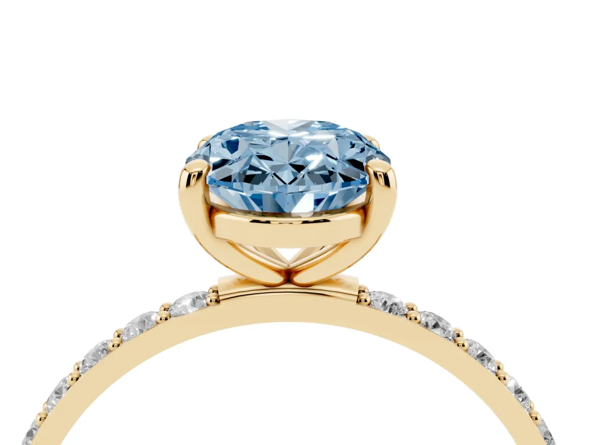 Fancy Blue Oval Cut Diamond Solitaire Ring with Round Pavé Band and Prong Setting Yellow gold