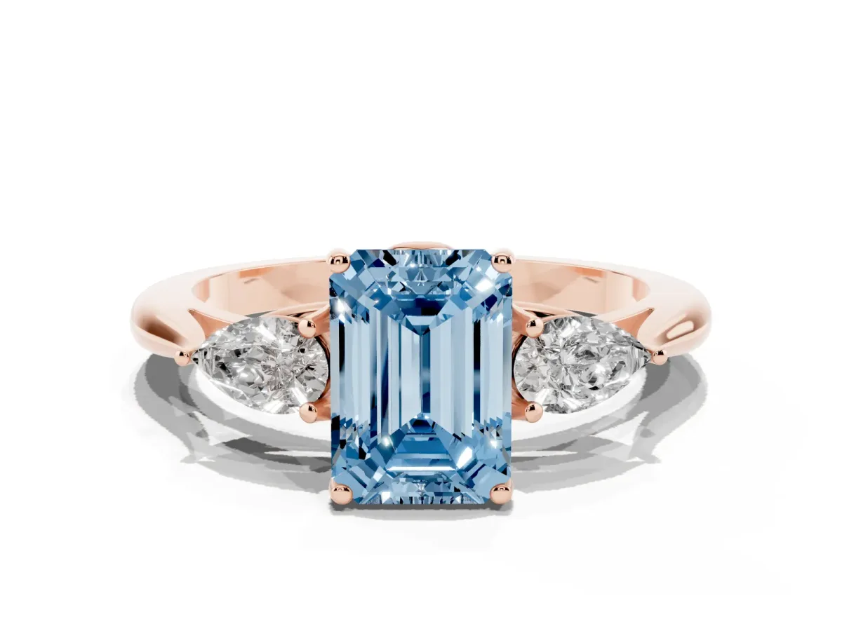 Fancy Blue Three-Stone Emerald Cut Diamond Ring with Pear Side Stones in Four-Prong Setting Rose gold