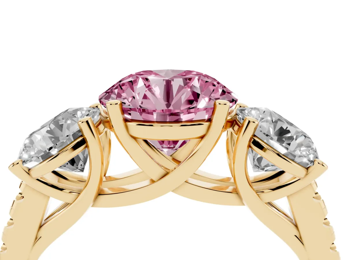 Fancy Pink Three-Stone Round Cut Diamond Ring with Round Pavé Band and Prong Setting Yellow gold