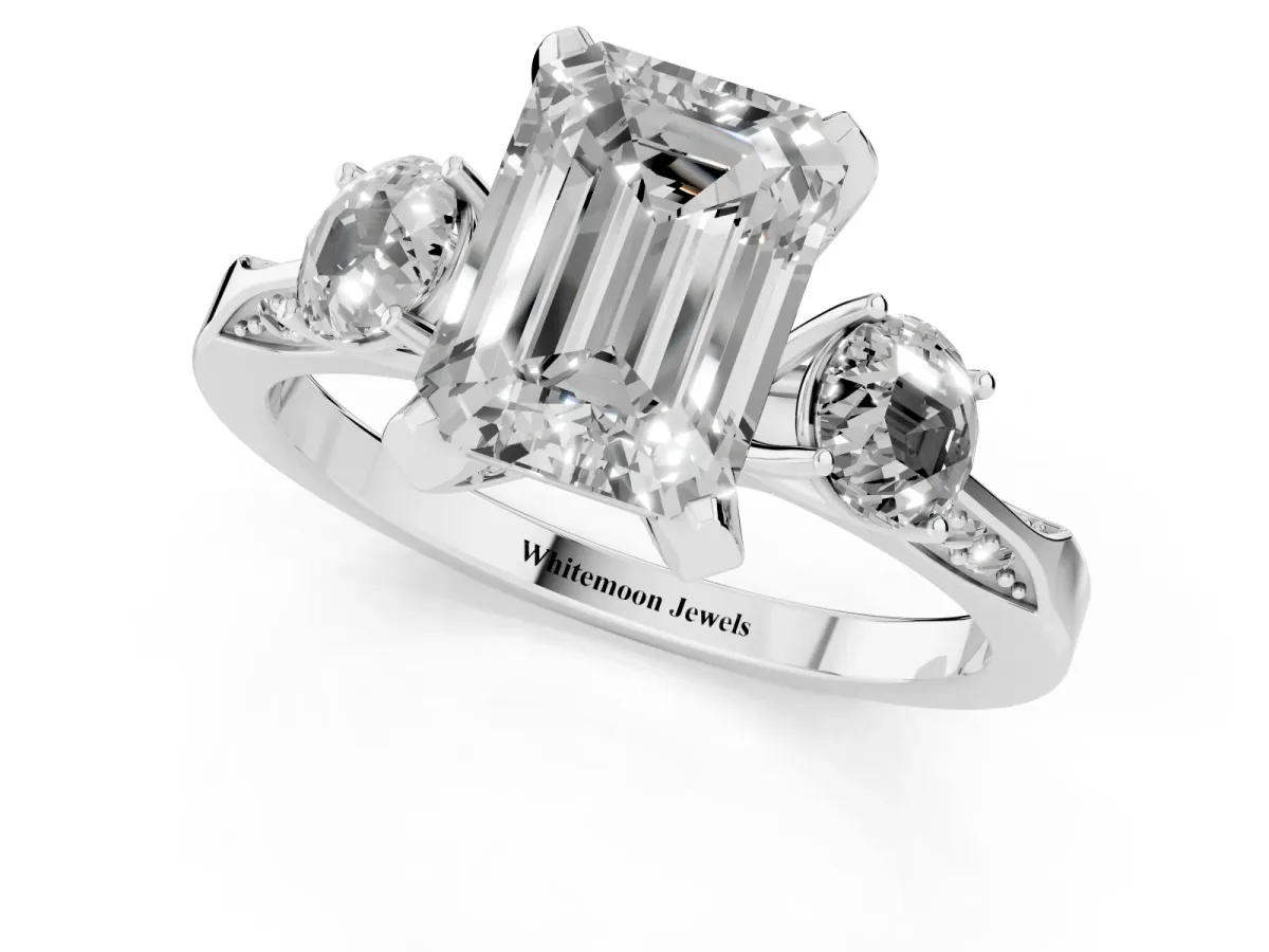 Fancy Pink Emerald Cut Brilliant Three-Stone Diamond Ring with Pavé Band and Four-Prong Setting White gold