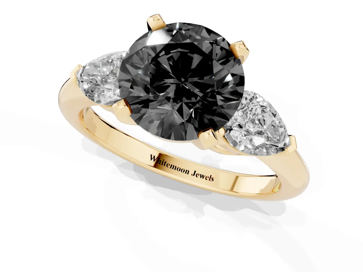 Fancy Black Three-Stone Round Cut Diamond Ring with Pear Side Stones and Four-Prong Setting Yellow gold
