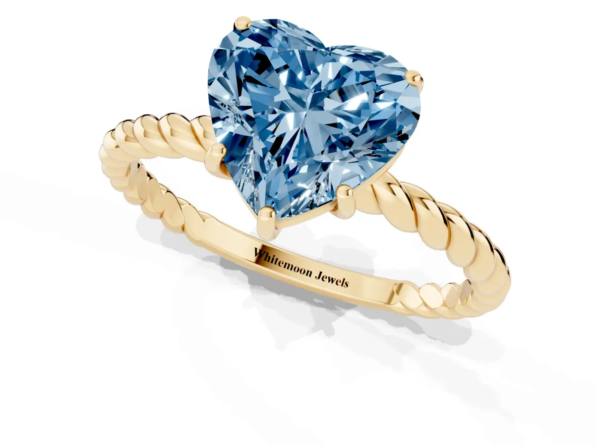 Fancy Blue Heart Cut Solitaire Twist Band Ring with Four-Prong Setting Yellow gold