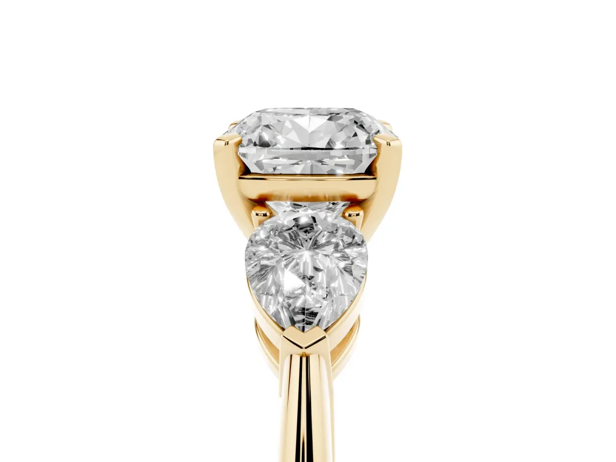 Three-Stone Cushion Cut Diamond Ring with Pear Side Stones and Four-Prong Setting Yellow gold