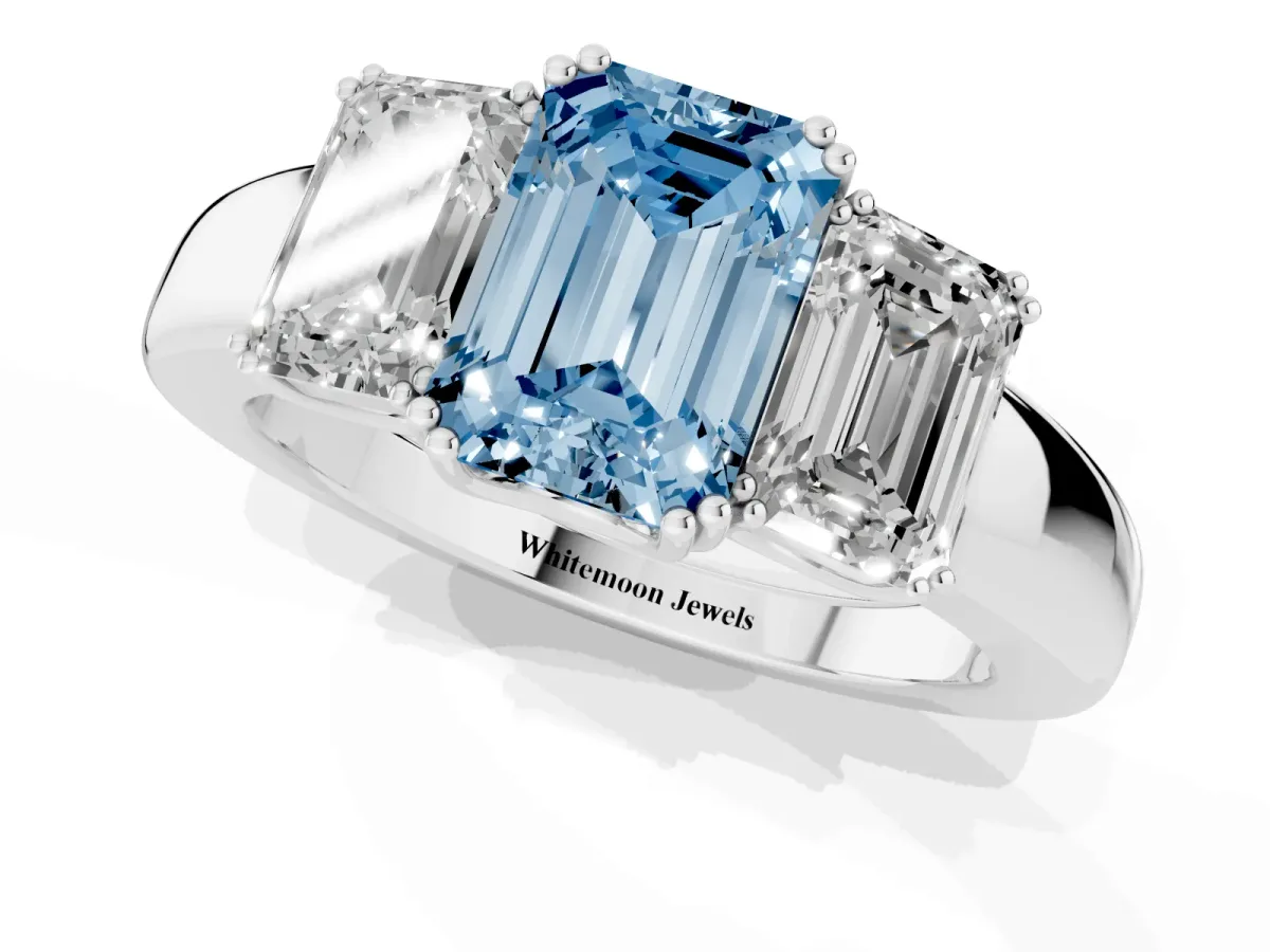 Fancy Blue Three-Stone Emerald Cut Cut Diamond Ring with Channel Set Band and Four-Prong Setting Silver