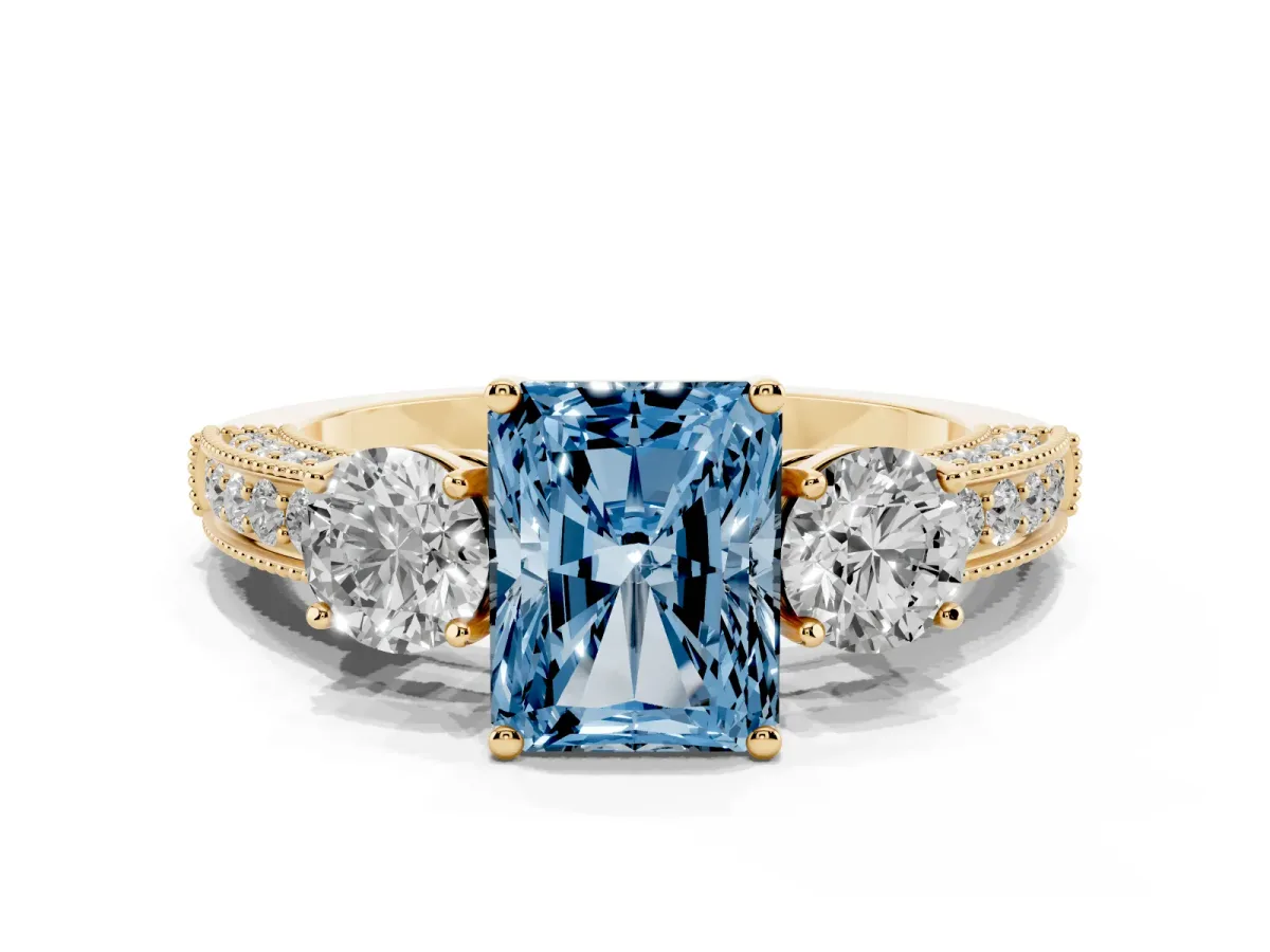 Fancy Blue Radiant Cut Three-Stone Diamond Ring with Pavé Band and Four-Prong Setting Yellow gold