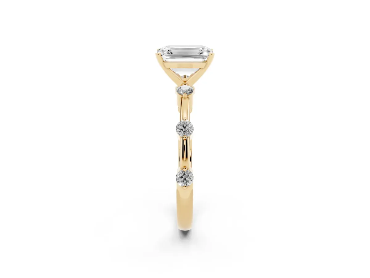 Emerald Cut Solitaire Diamond Ring with Bezel Set Side Stones and Prong Setting Yellow gold