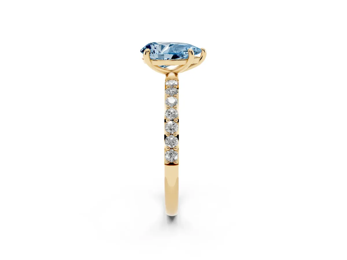 Fancy Blue Pear Cut Diamond Solitaire Ring with Round Pavé Band and Prong Setting Yellow gold