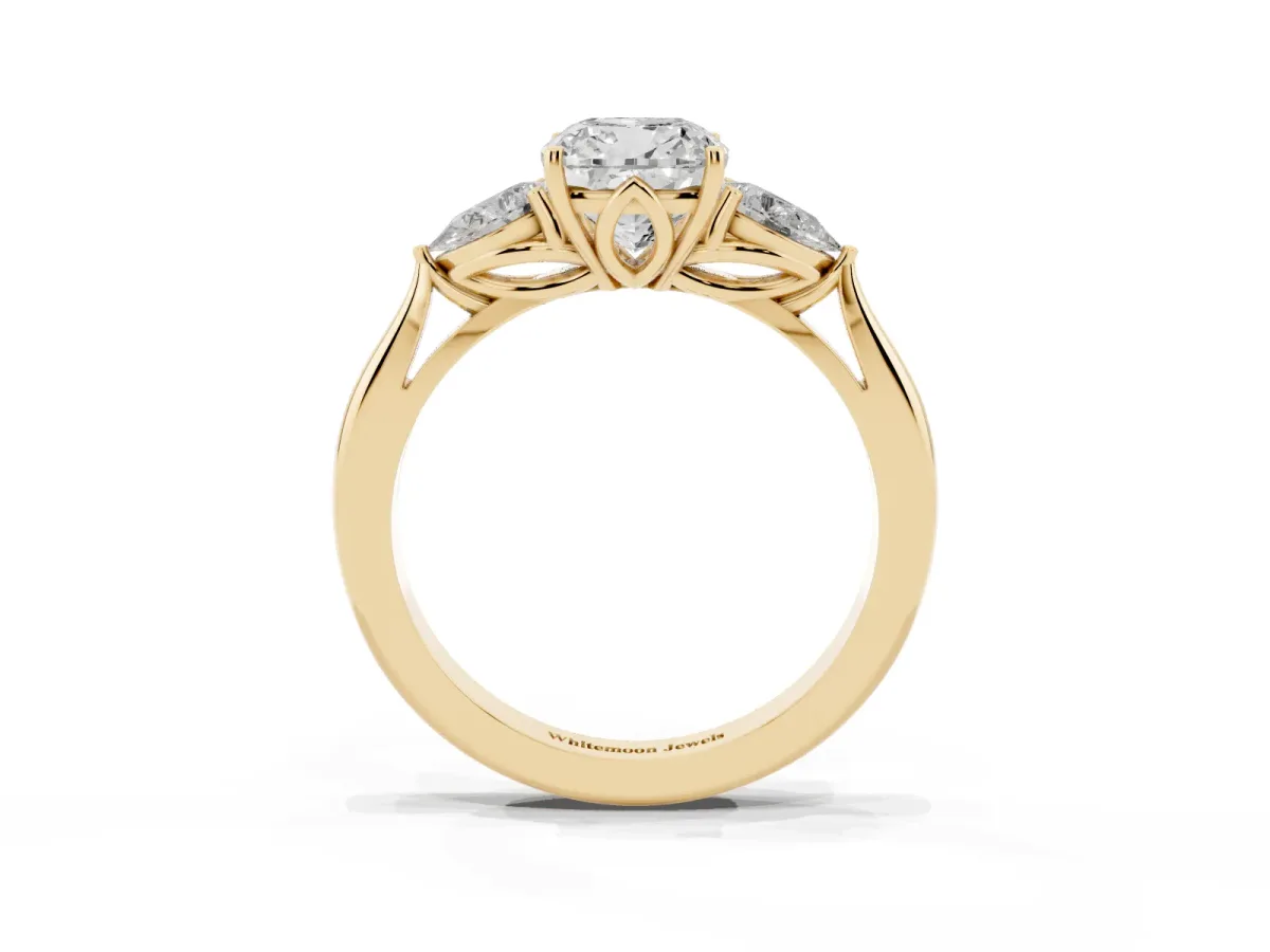 Three-Stone Cushion Cut Diamond Ring with Pear Side Stones in Four-Prong Setting Yellow gold