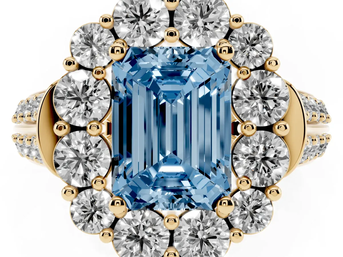 Fancy Blue Emerald Cut Halo Diamond Engagement Ring with Split Shank and Prong Setting Yellow gold