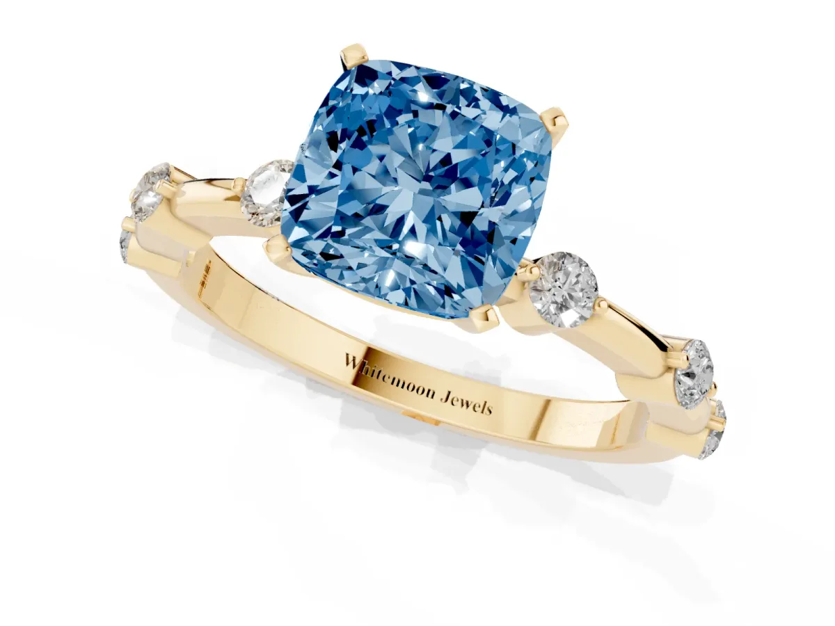 Fancy Blue Cushion Cut Solitaire Diamond Ring with Bezel Set Side Stones and Prong Setting Yellow gold