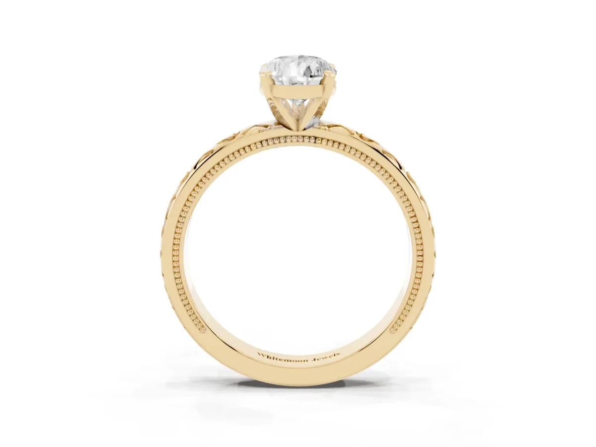 Pear Cut Solitaire Diamond Engagement Ring with XO Engraved Band and Four-Prong Setting Yellow gold