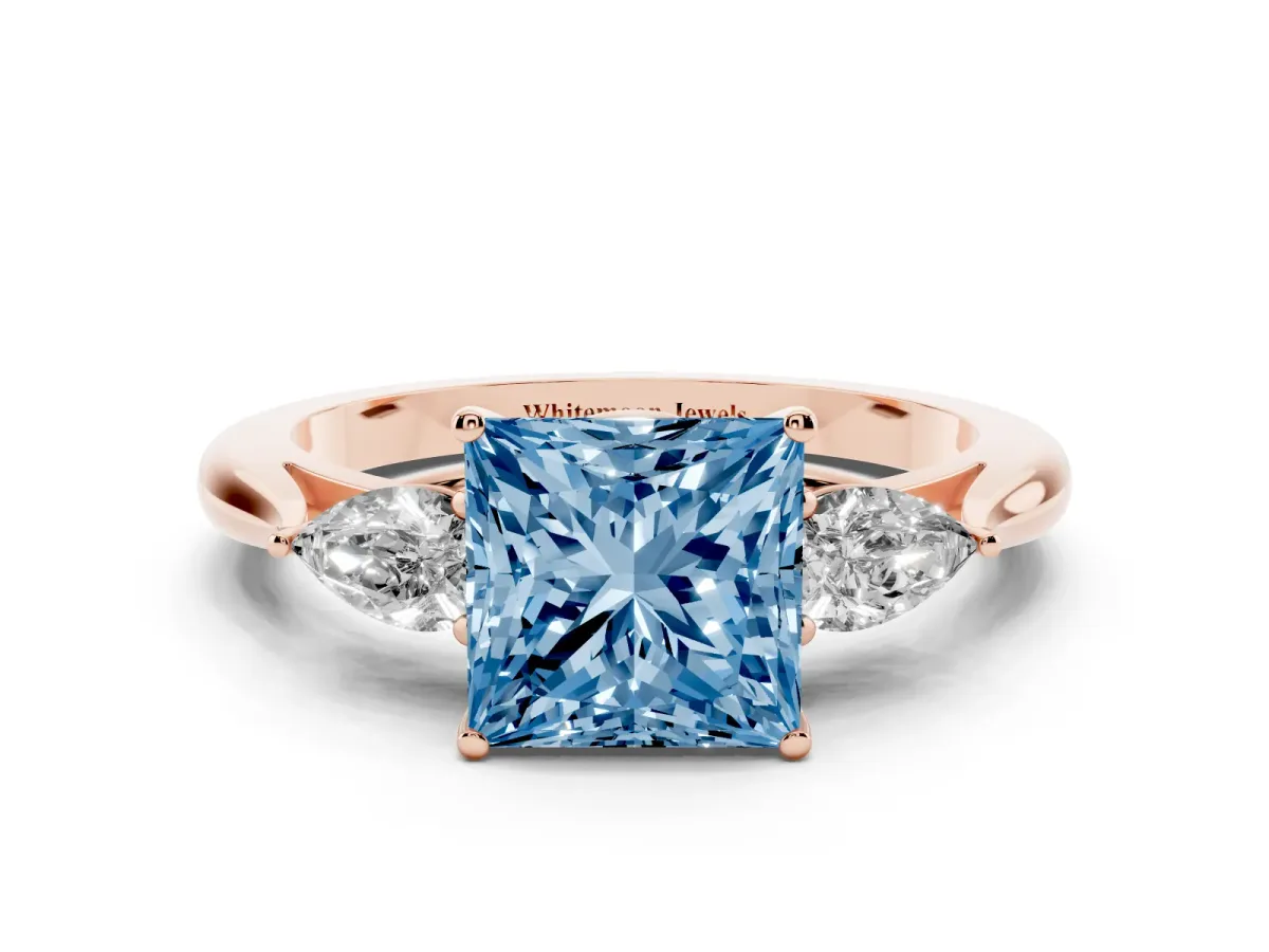 Fancy Blue Three-Stone Princess Cut Brilliant Diamond Solitaire Ring with Tapered Band and Four-Prong Setting Rose gold
